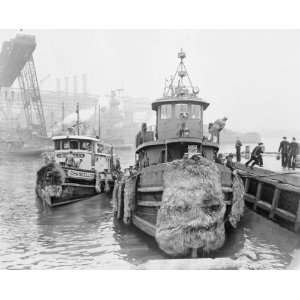   docks at the Brooklyn navy yard pier as a commercial tugboat departs t