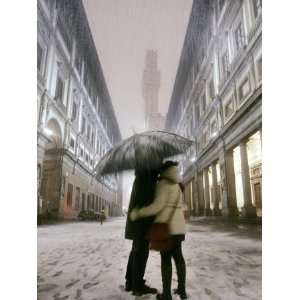 Couple Kiss Each Other During a Snowfall in Florence, Italy Premium 