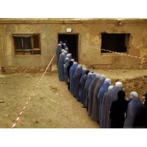 Afghan Women Wearing Burqa Line up to Vote at a Polling Station 