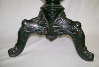 Old wooden piano stool, with 3 legged cast iron ornate legs. Seat is 